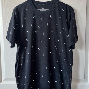 Nike Men's Black Tee with White Swoosh Pattern